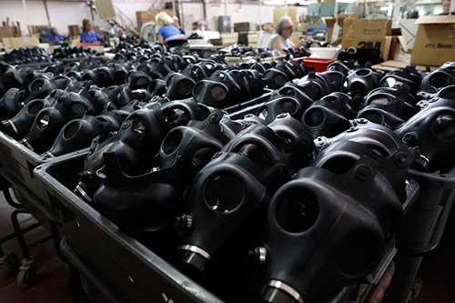 Israeli workers are seen at the Shalon gas mask factory in Kiryat Gat